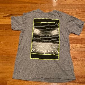 l (14/16) grey xersion shirt with black, white and neon football field design
